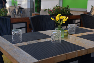 The decor of the restaurant on the street. Laid table