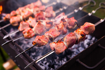 Appetizing juicy shish kebab on skewers fried on grill