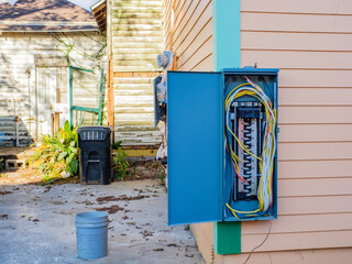 New, Open Circuit Box on Old Home that is Otherwise Neglected with Peeling Paint, Broken Screen...