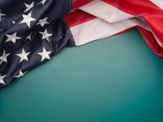 Top view of the American flag on a green background with copy space for text