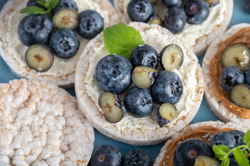 Open sandwich with blueberries. Made from rice crispbreads and peanut butter, healthy nutritious snack option, vegan food