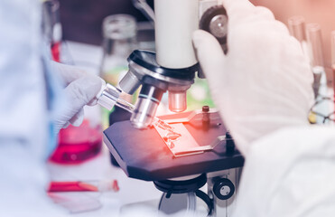 scientist with equipment and science experiments laboratory glassware containing chemical liquid....