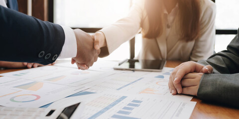Two confident business man shaking hands during a meeting in the office, success, dealing, greeting and partner concept. © wichayada