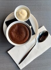 Delicious Warm Gourmet Dark Chocolate Melted Centre Surrounded by Cake served with Vanilla Ice Cream; Perfect warm cold summer evening. Fondant au Chocolat - gâteau au Chocolat à la texture fondant.