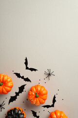 Halloween concept. Top view photo of pumpkins spiders bat silhouettes and black confetti on...