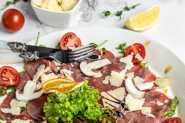 Beef Carpaccio with parmesan, capers and arugula. cold appetizer. banner, menu, recipe place for text, top view