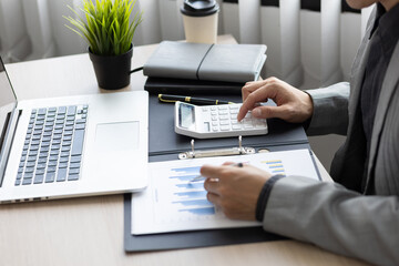 Businessman working about financial with calculator at office to calculate expenses. Accountant...
