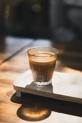 A glass of espresso shot over cold fresh milk. Dirty Coffee, Coffee menu, Milk Coffee