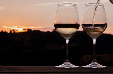 Elegant wine glasses at sunset
