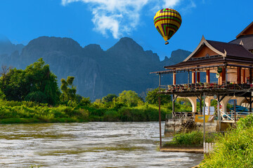 Hot Air Balloon over Vang Vieng Laos a beautiful city on the river with huge rising mountains and...