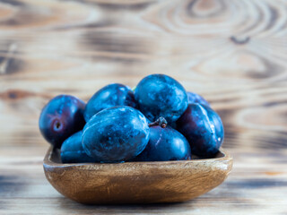 Fresh juicy plums. Plums on a wooden background.