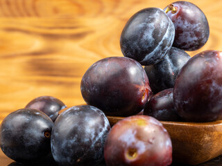 Fresh juicy plums. Plums on a wooden background.