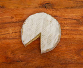 Cheese camembert on wooden cutting board