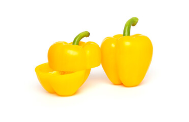 Whole and half of yellow bell pepper or paprika isolated on white background