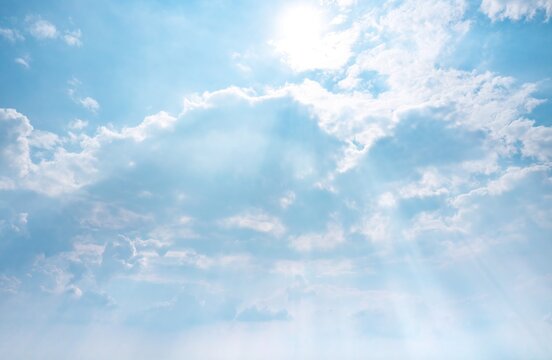 Blue sky, white clouds and light rays