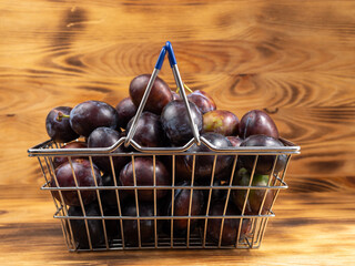 Fresh juicy plums. Plums on a wooden background.