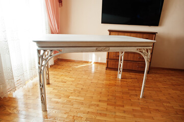 White wooden carved table in flat.