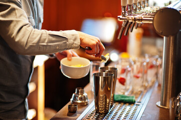 Barman making alcohol cocktail in restaurant.