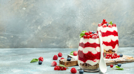 Cranachan raspberry dessert in jar on a lighr background. Long banner format