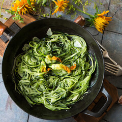 pan with zucchini spaghetti on the table