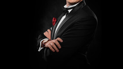 Element of the image of a man dressed in a tuxedo on a dark background.