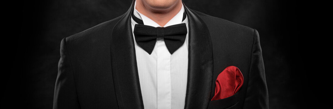 Element of the image of a man dressed in a tuxedo on a dark background.