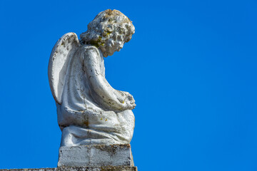 Fototapeta na wymiar Seraphim angel praying with hands clasped for faith and hope of better days