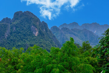 Fototapeta na wymiar Vang Vieng Laos a beautiful city on the river with huge rising mountains and slow flowing river. 