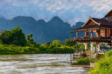 Obraz premium Vang Vieng Laos a beautiful city on the river with huge rising mountains and slow flowing river. 