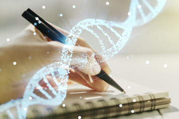 Creative concept with DNA symbol illustration and woman hand writing in notebook on background....