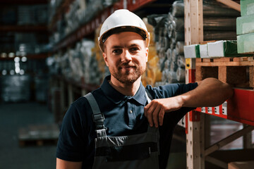In dark store. Employee in uniform is working in the storage