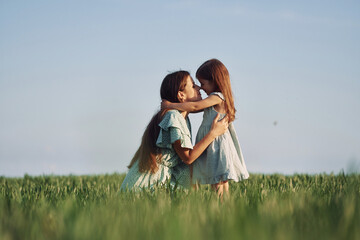 Moment of tenderness. Mother and daughter have fun outdoors on the field at summer