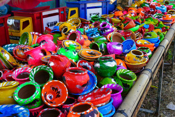 Obraz premium Mini kitchen utensils pottery toys made from clay that are painted in colorful colors so that they attract the attention of children buyers.