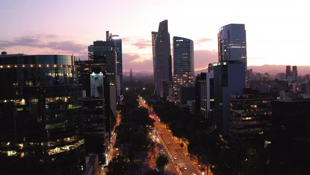 Aerial Upward Shot Of Illuminated Modern Buildings In City During Sunset - Mexico City, Mexico