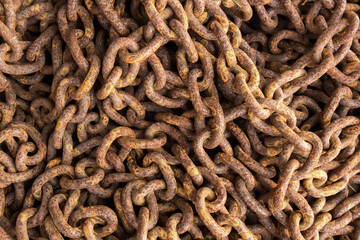 Closeup of old weathered rusty giant metallic chains


