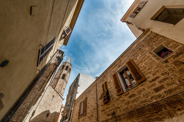 Fototapeta na wymiar Alghero cathedral and narrow alley in the Old town