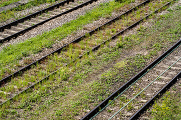 empty railroad tracks overgrown with grass. without carriages