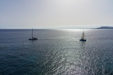 Obraz premium Seascape with sun reflection. Pleasure yachts in the sea.