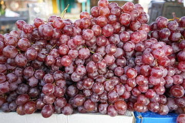 Sweet red grapes are sold in roadside fruit shops in Indonesia. This fruit is imported from abroad. This fruit has small seeds in it which when chewed are very bitter in taste.