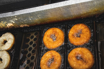 Image of deep fried unhealthy donut. Saturated fats carcinogenic doughnouts industry. Mass...