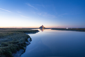 Sunset over Mont Saint Michel, monumental architecture of thousands years in France