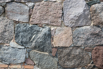 Stone wall with different colors and size of rocks