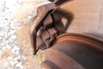Old brake pads in worn car brake systems.
