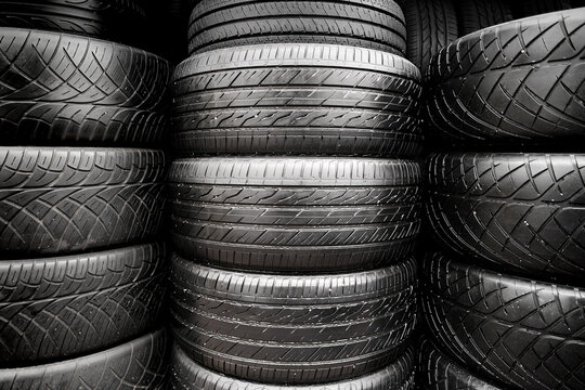 Stacks of old tires put together in the automobile tyre shop