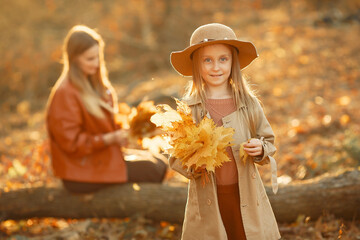 Cute and stylish family in a autumn park