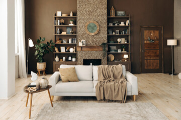 Modern stylish living room with large windows and beige sofa on the backgroung of brown wall with...