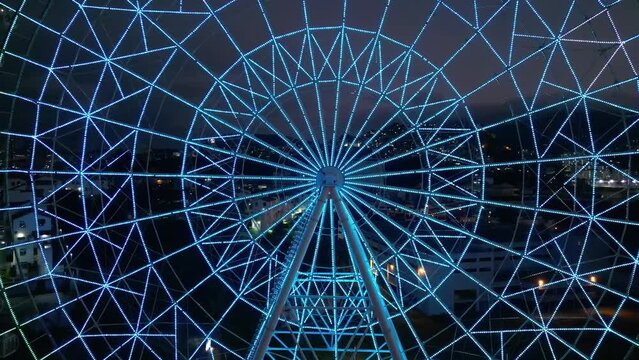 Rio de Janeiro, Brazil - August 3, 2022: Aerial view of Yup Star (Rio Star) ferris wheel at night is illuminated with colorful RGB led lights.