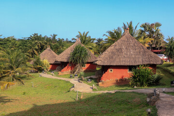 Fototapeta na wymiar Traditional African Houses on the Axim Tropical Beach in Ghana, West Africa