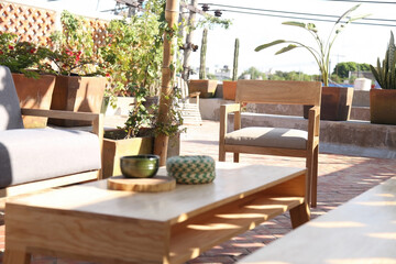 Fototapeta na wymiar Patio. Garden. Urban, neutral, outdoor living space. Exterior photo. Outdoor living room with couch