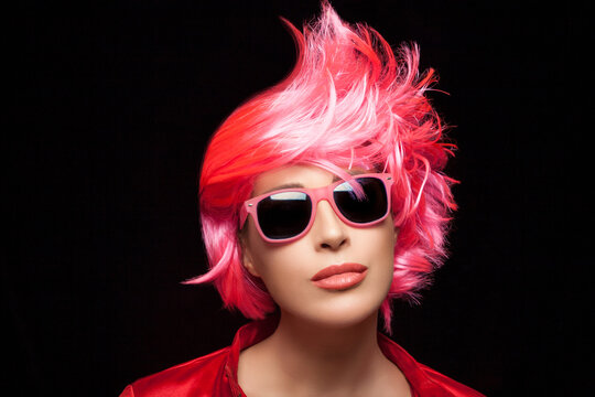 Fashionable woman with stylish dyed pink hair
